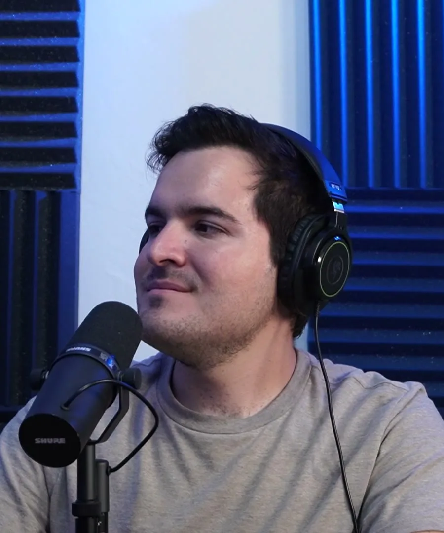 César Hernández at the studio, with headphones and a microphone